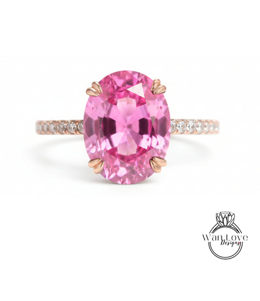 A pink gemstone ring with a large oval-shaped gemstone set in a rose gold band.