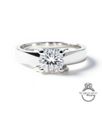 A close-up view of a silver ring with a large, round diamond set in the center.