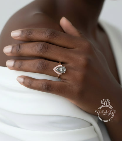 A close-up of a person's hand wearing a ring with a large, clear gemstone.