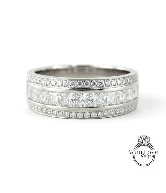 A silver band ring with a row of diamonds set in it.