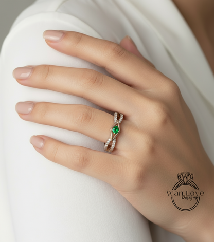 A close-up of a hand wearing a ring with a green gemstone.