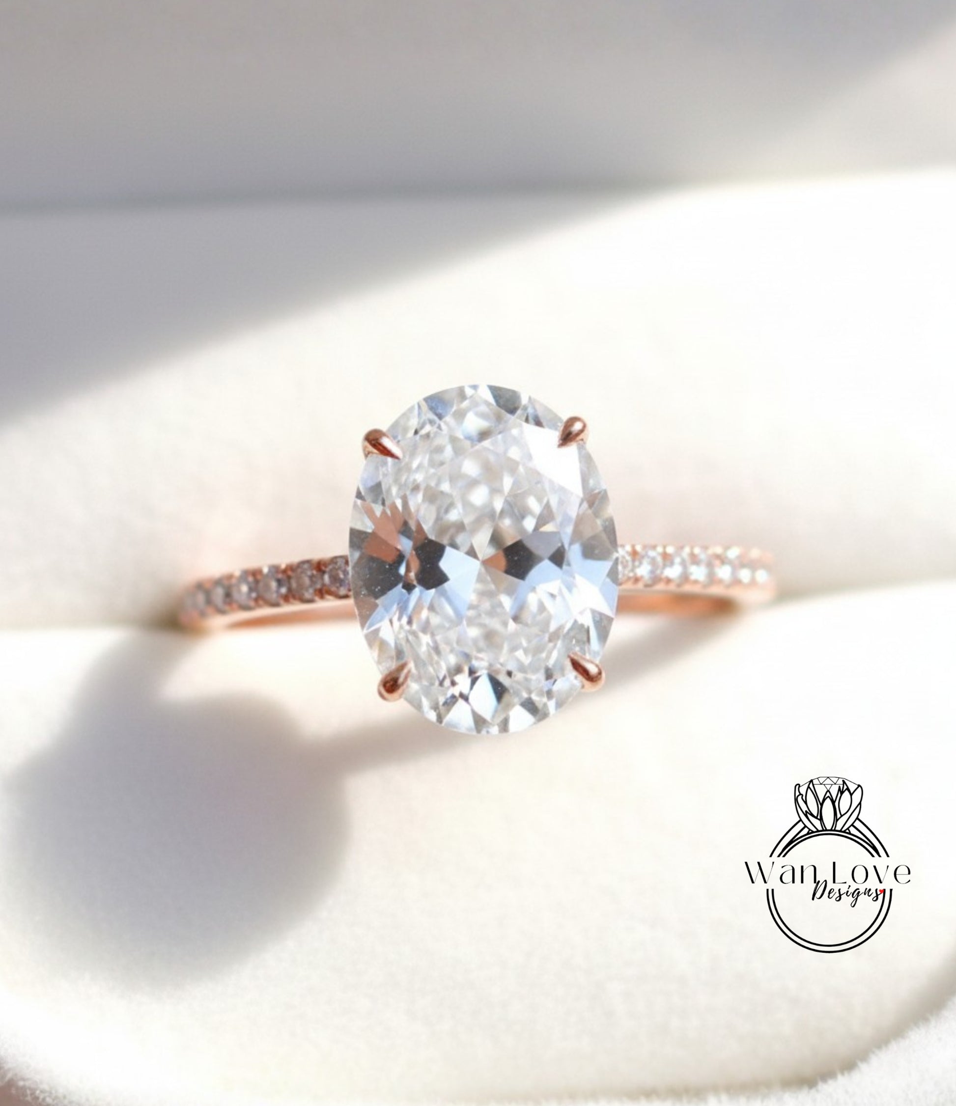A close-up image of a diamond engagement ring with a large oval-shaped diamond set in a rose gold band.