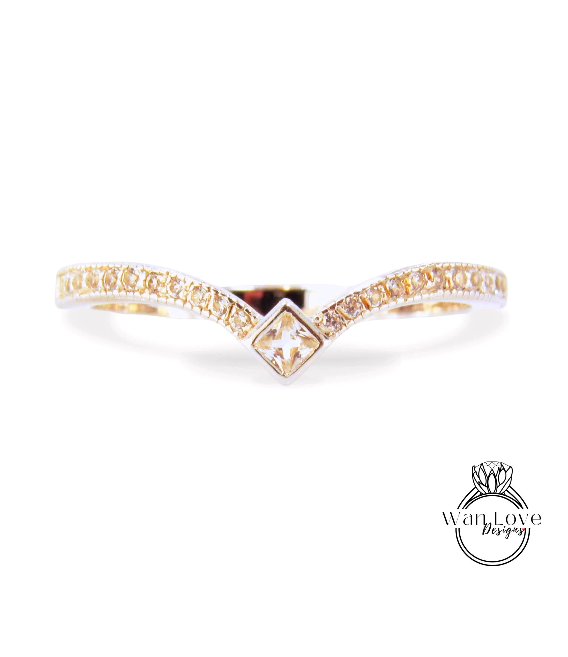 A gold ring with a diamond-encrusted band and a square-shaped gemstone in the center.