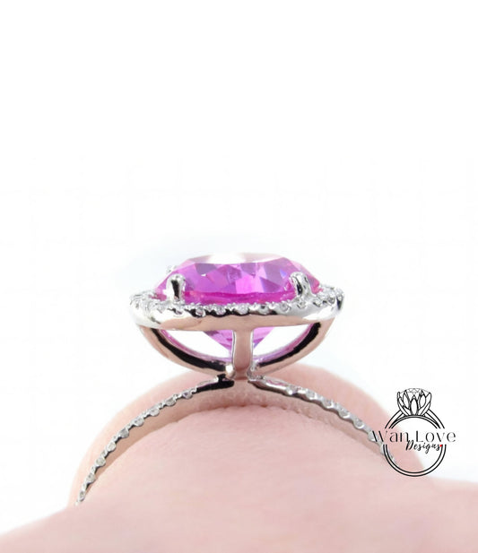 A close-up view of a large, pink gemstone set in a silver ring.
