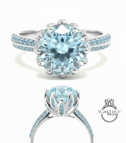 A stunning blue diamond engagement ring with a large central diamond surrounded by smaller diamonds set in a silver band.