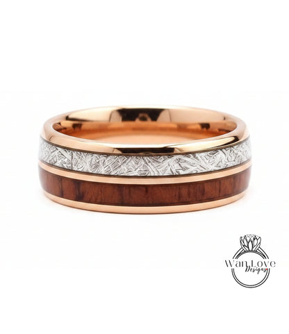 A gold-toned ring with a wooden band and a metallic band with a patterned design.