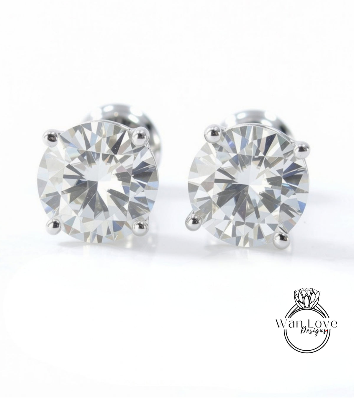 A pair of elegant diamond earrings with a large, brilliant-cut diamond set in a silver metal frame.