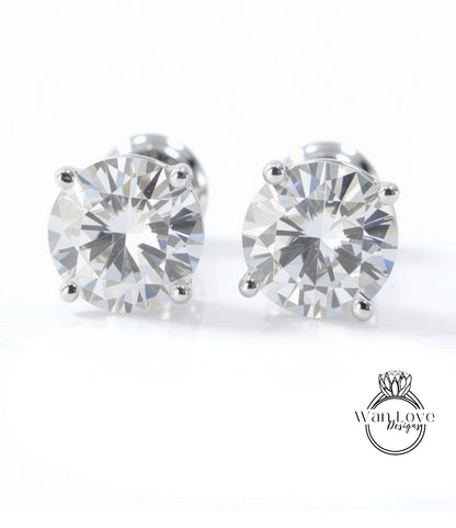 A pair of elegant diamond earrings with a large, brilliant-cut diamond set in a silver metal frame.