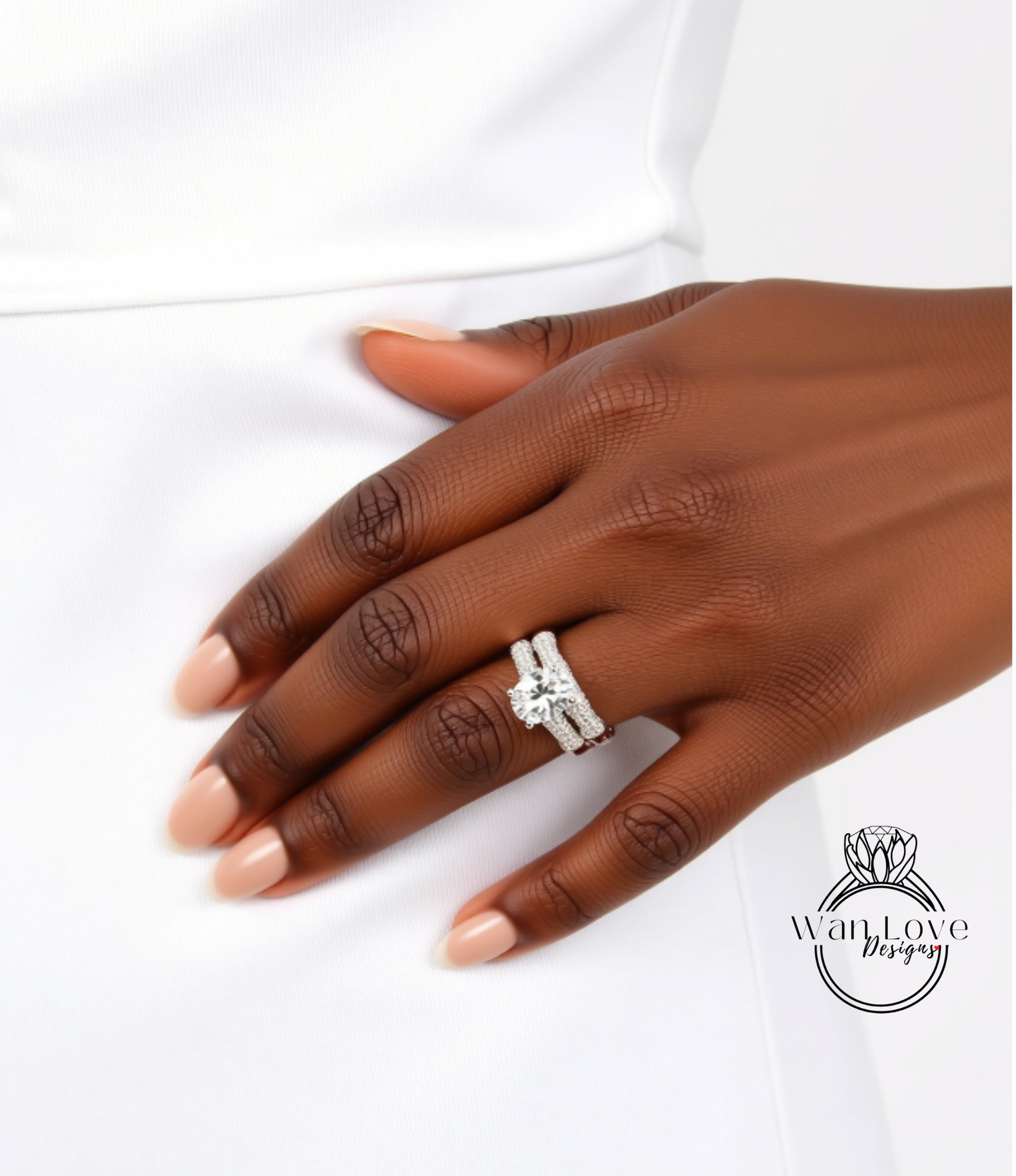 A close-up of a person's hand wearing a diamond engagement ring.