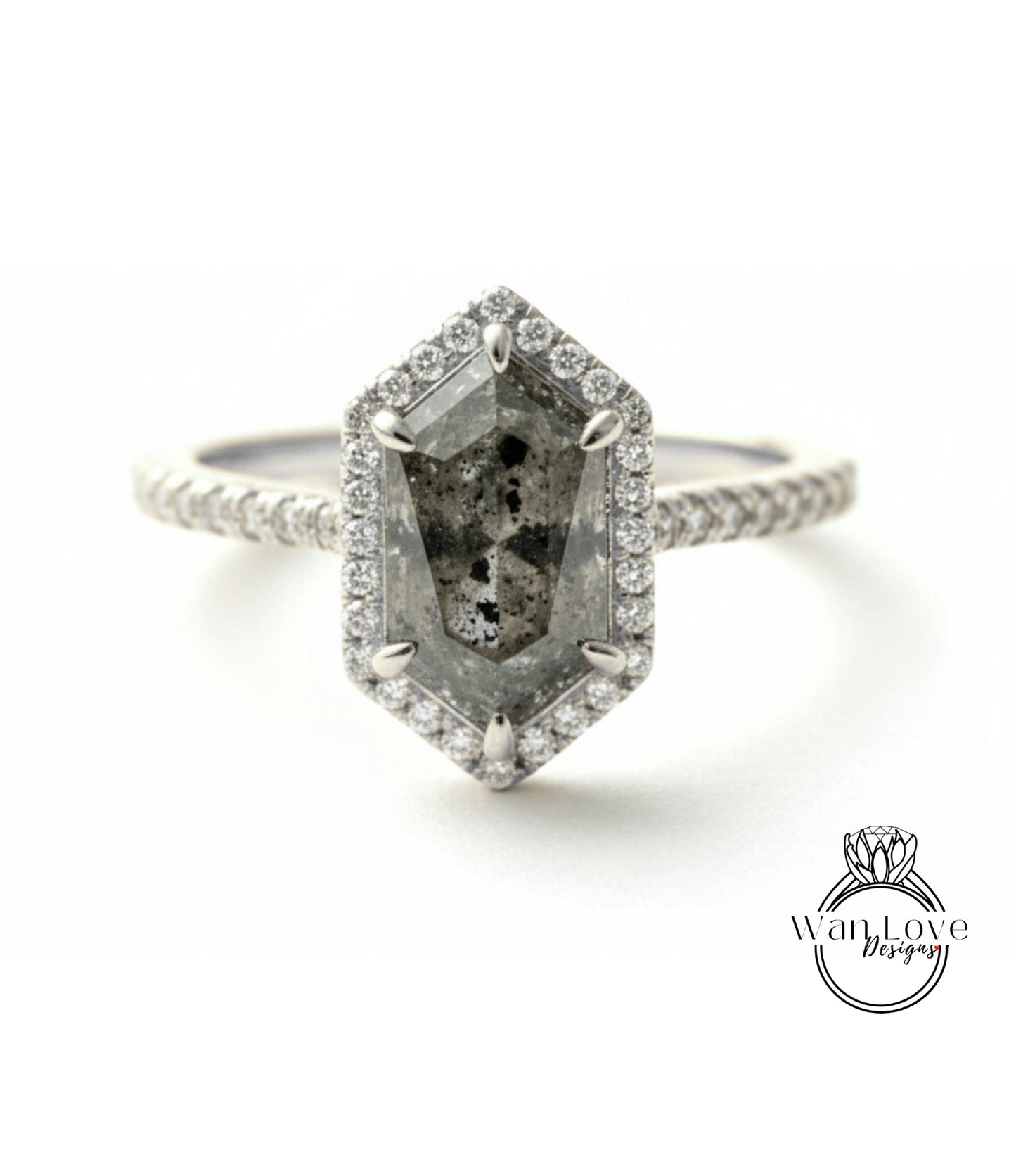 A silver ring with a large, irregularly shaped diamond as the centerpiece, surrounded by smaller diamonds.