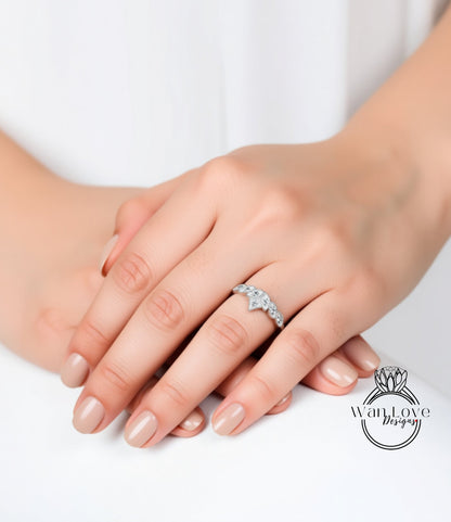 A close-up image of a person's hand wearing a diamond engagement ring.