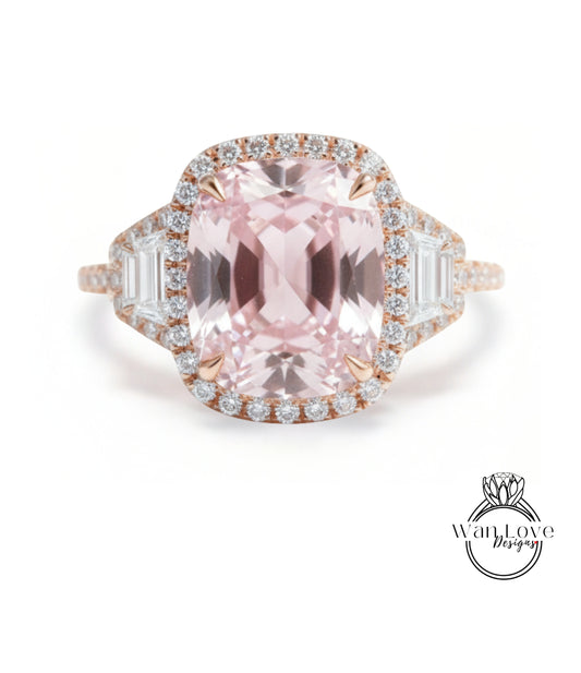 A stunning pink gemstone ring with a halo of diamonds around the center stone.