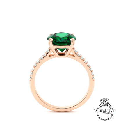 A rose gold engagement ring with a large green gemstone set in the center.