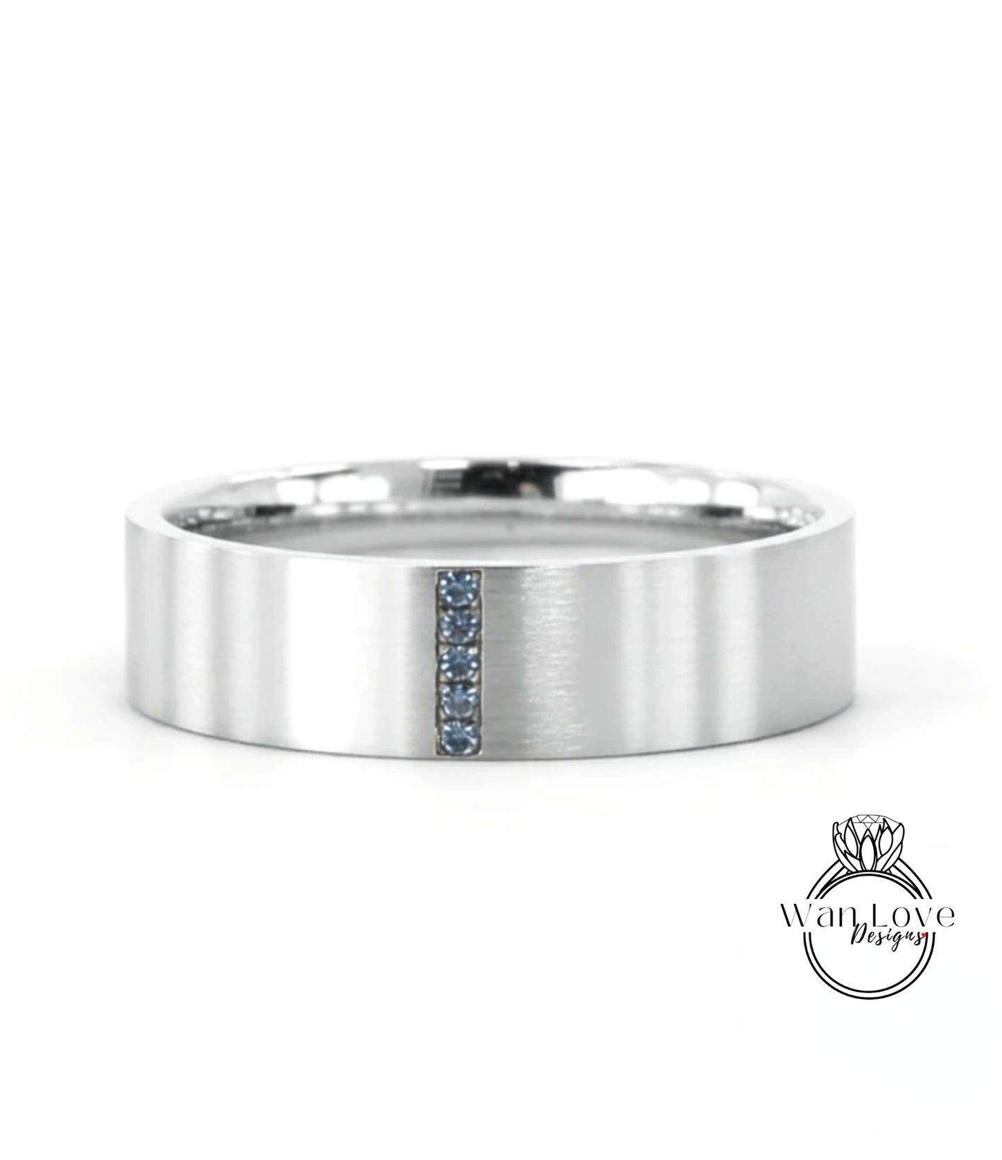 A silver-colored ring with a vertical blue gemstone in the center.