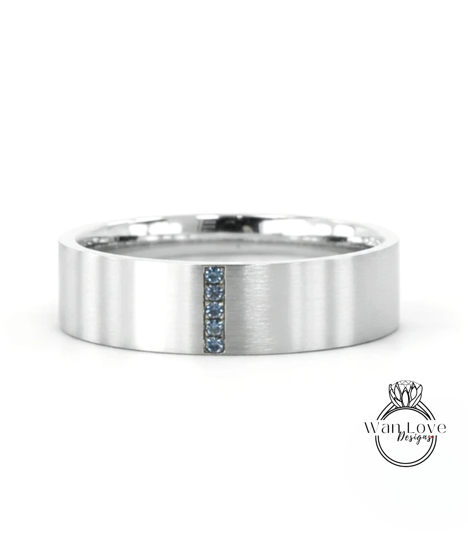 A silver-colored ring with a vertical blue gemstone in the center.