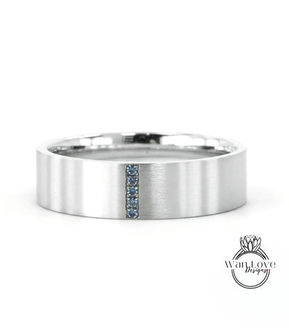 A silver-colored ring with a vertical blue gemstone in the center.