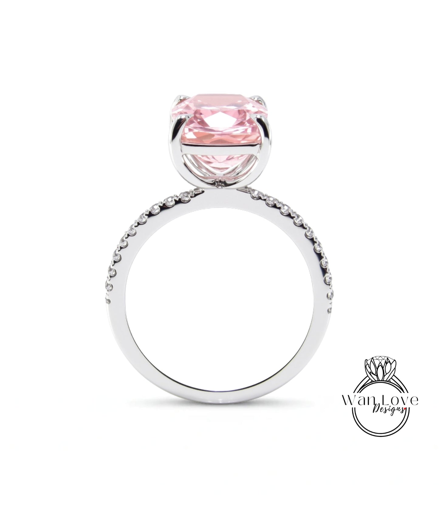 A silver ring with a large pink gemstone, likely a diamond, set in the center.