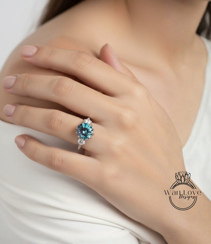 A close-up of a person's hand wearing a ring with a large blue gemstone.