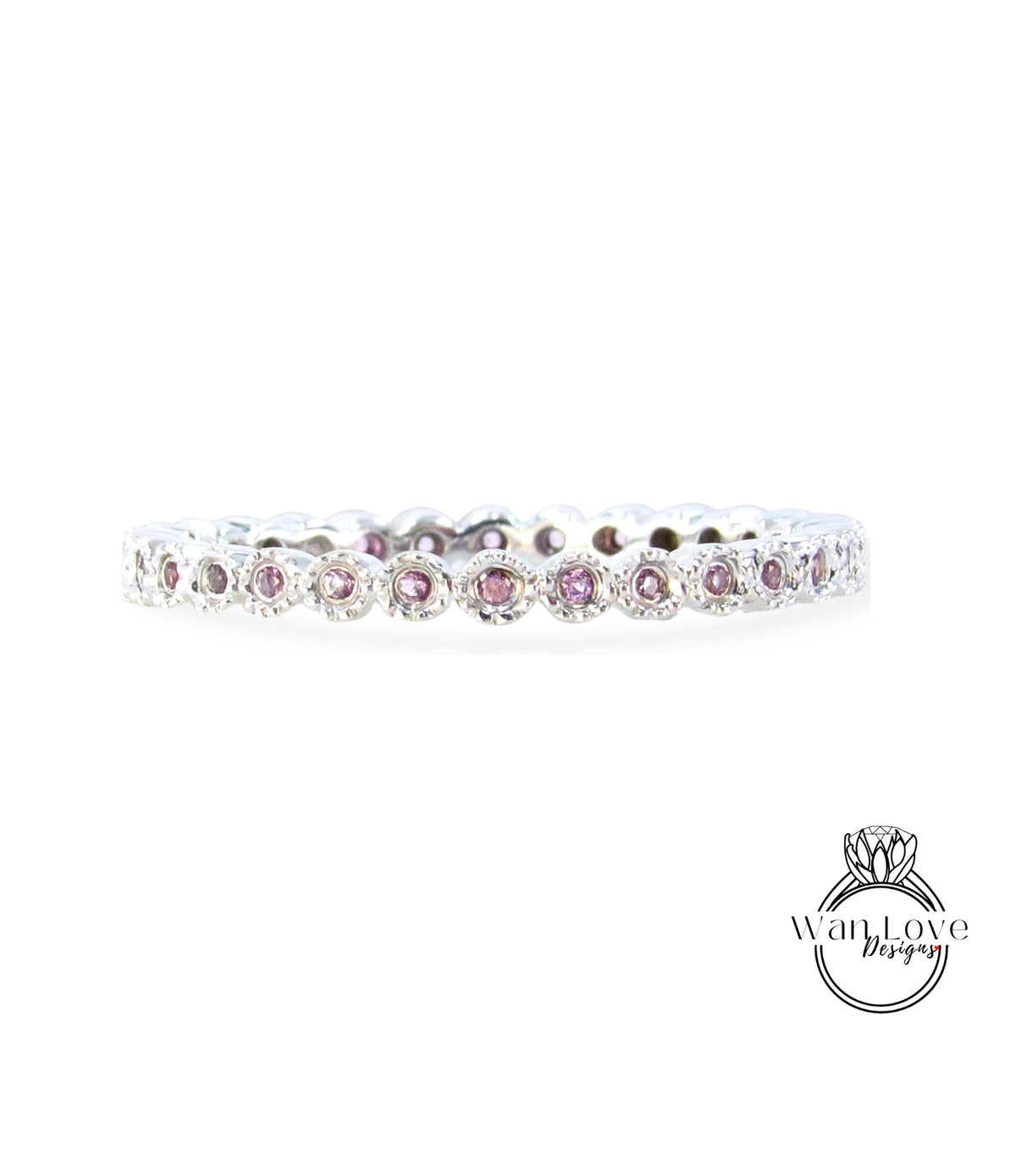 A silver band with a row of small, round, purple gemstones set in it.