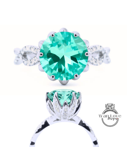 A close-up view of a silver ring with a large, round, turquoise gemstone at the center. The ring is adorned with smaller diamonds around the gemstone, creating a sparkling effect.