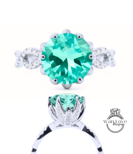 A close-up view of a silver ring with a large, round, turquoise gemstone at the center. The ring is adorned with smaller diamonds around the gemstone, creating a sparkling effect.