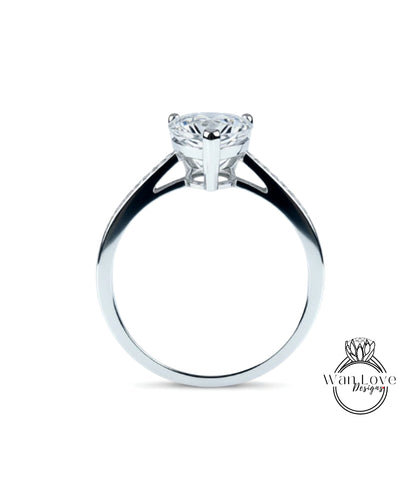 A silver engagement ring with a large diamond set in the center.