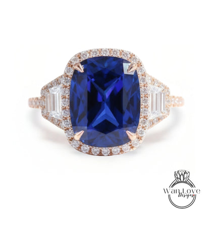 A large, blue gemstone ring with a halo of smaller diamonds around the center stone.