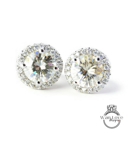 A pair of elegant earrings with large, clear gemstones set in a halo of smaller diamonds, creating a sparkling and sophisticated appearance.