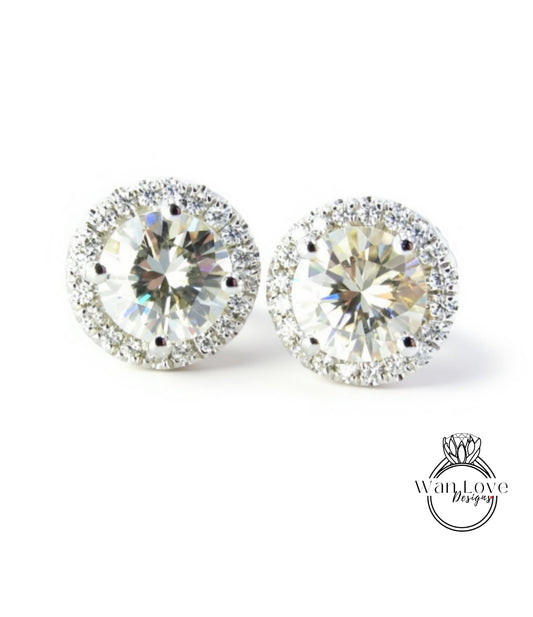 A pair of elegant earrings with large, clear gemstones set in a halo of smaller diamonds, creating a sparkling and sophisticated appearance.