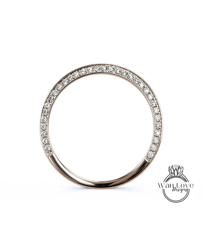 A silver ring with a row of small diamonds set in the center.