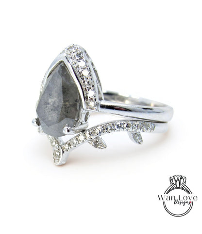 A silver ring with a large diamond as the centerpiece, surrounded by smaller diamonds and set in a band.