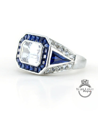 A silver ring with a large blue gemstone in the center, surrounded by smaller blue gemstones.