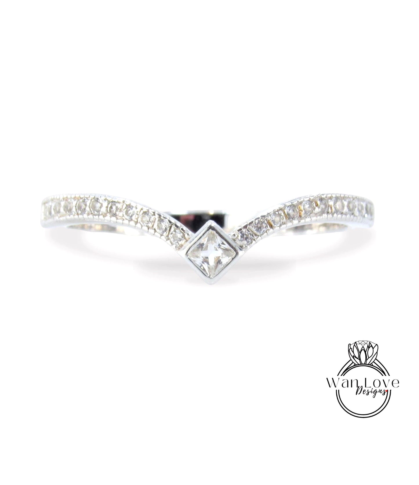 A silver ring with a diamond-encrusted band and a central square-shaped diamond.