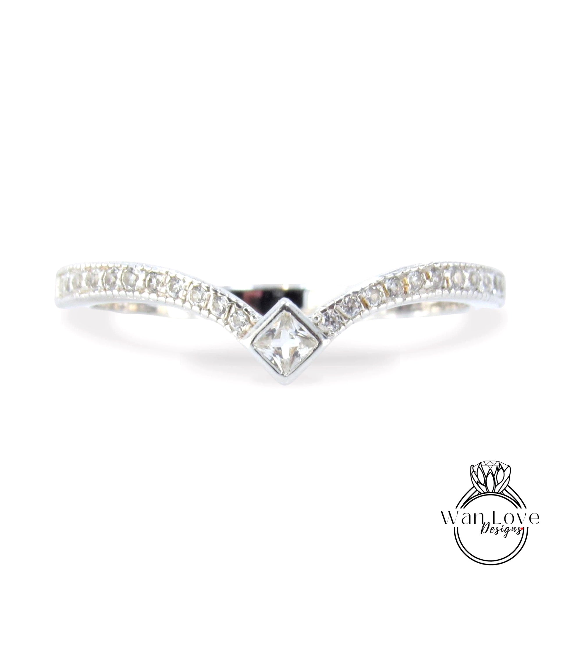 A silver ring with a diamond-encrusted band and a central square-shaped diamond.