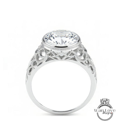 A close-up of a silver ring with a large, round diamond at the center, showcasing the intricate design and craftsmanship of the piece.
