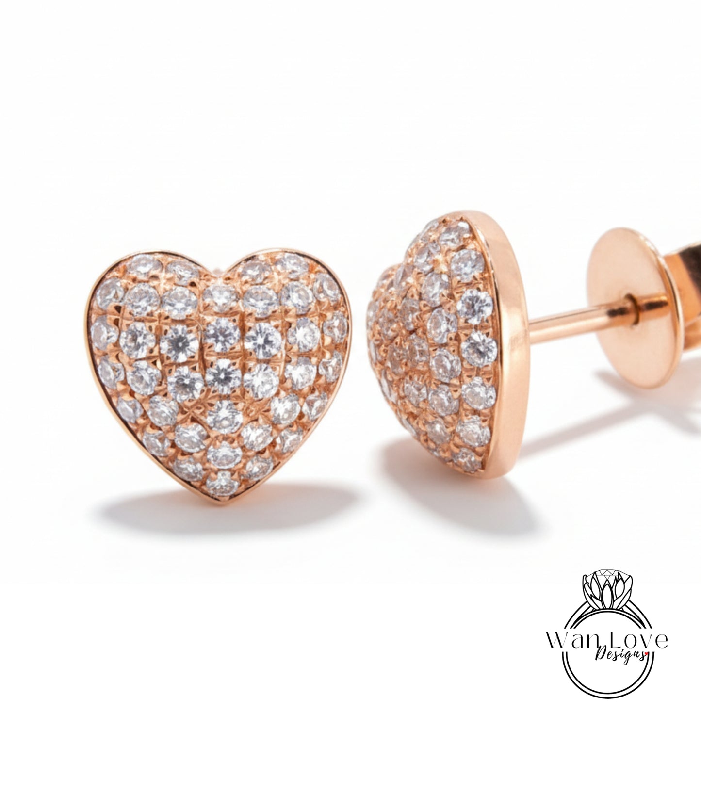 a pair of elegant diamond-encrusted heart-shaped earrings, showcasing their intricate design and sparkling beauty.