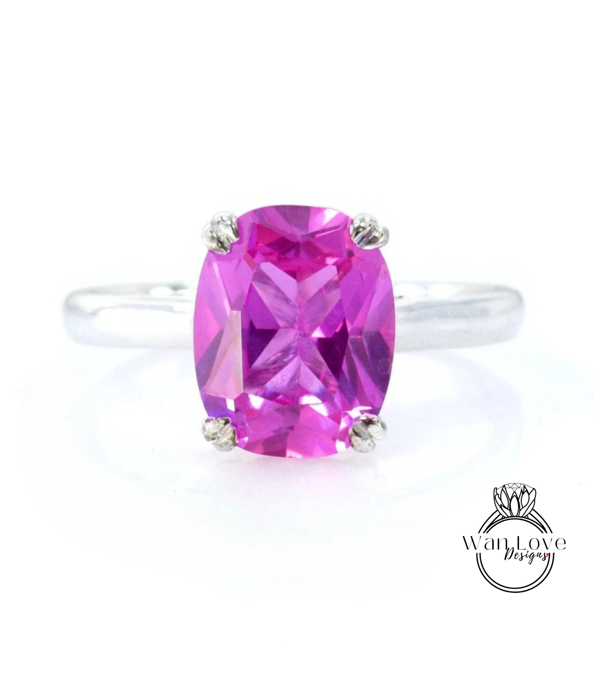A ring with a large, bright pink gemstone, likely a pink gemstone like a ruby or a pink topaz, set in a silver band.