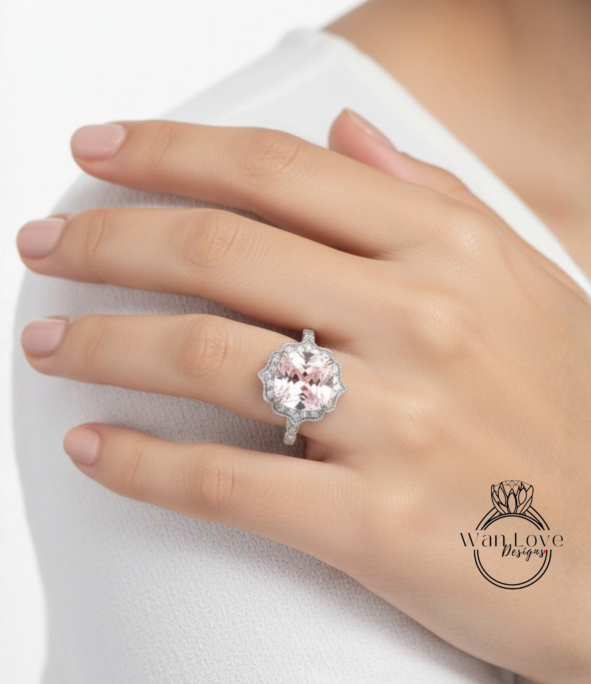 A close-up of a person's hand wearing a large, pink gemstone ring on the ring finger.
