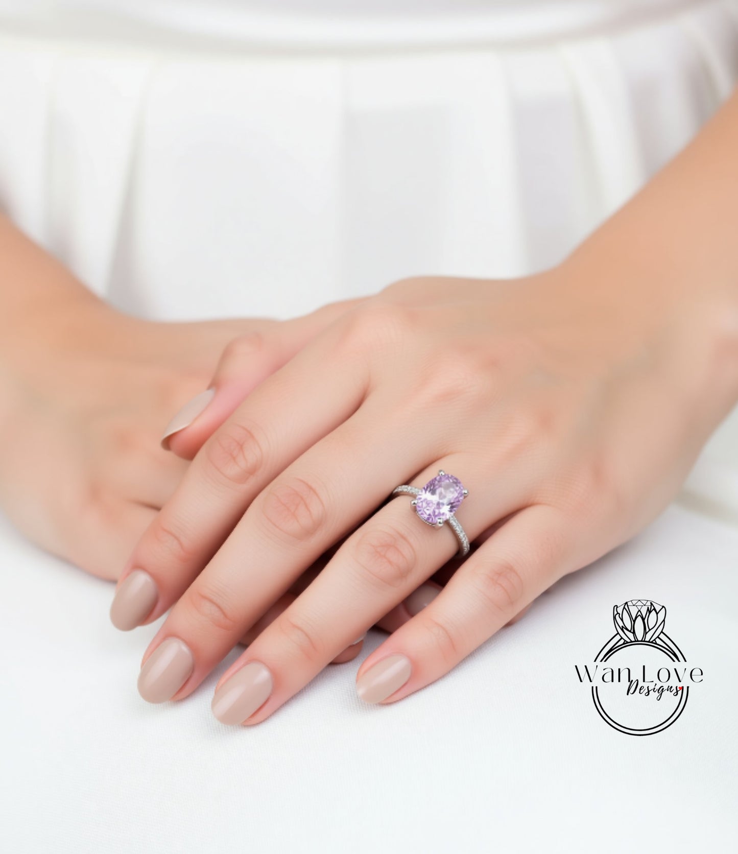 A close-up of a person's hand wearing a ring with a large, purple gemstone.