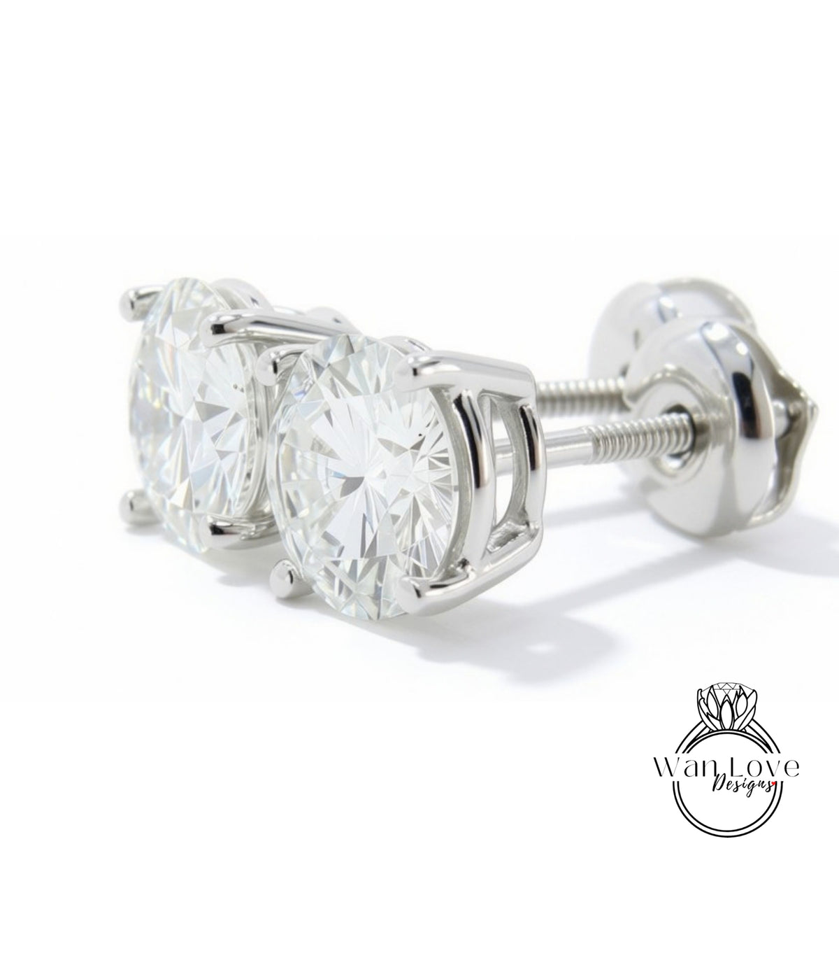 A pair of elegant silver earrings with large, clear diamonds set in a white metal frame.