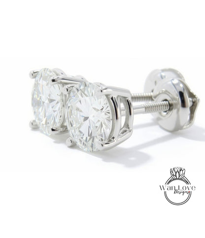 A pair of elegant silver earrings with large, clear diamonds set in a white metal frame.