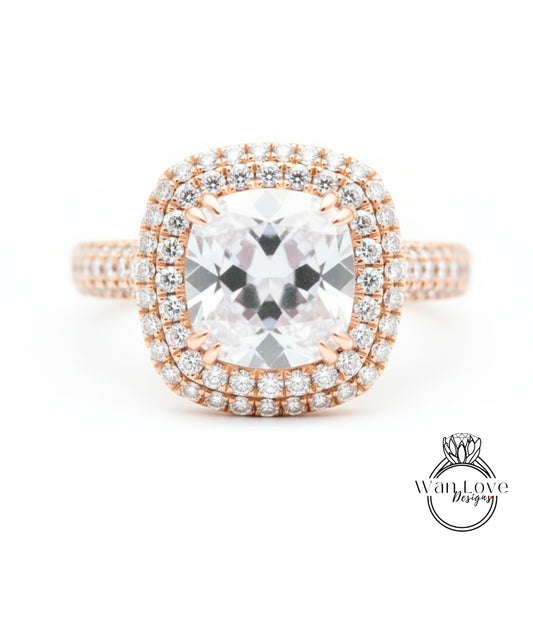 A close-up image of a diamond engagement ring with a large central diamond surrounded by smaller diamonds set in a halo of smaller diamonds.