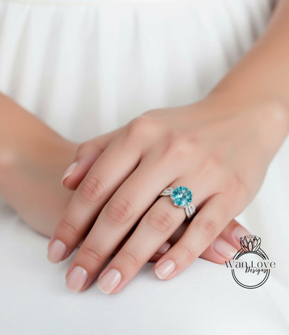 A close-up of a person's hand wearing a ring with a large blue gemstone.