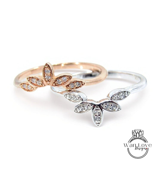 Two rings with flower-shaped gemstones are displayed against a white background.