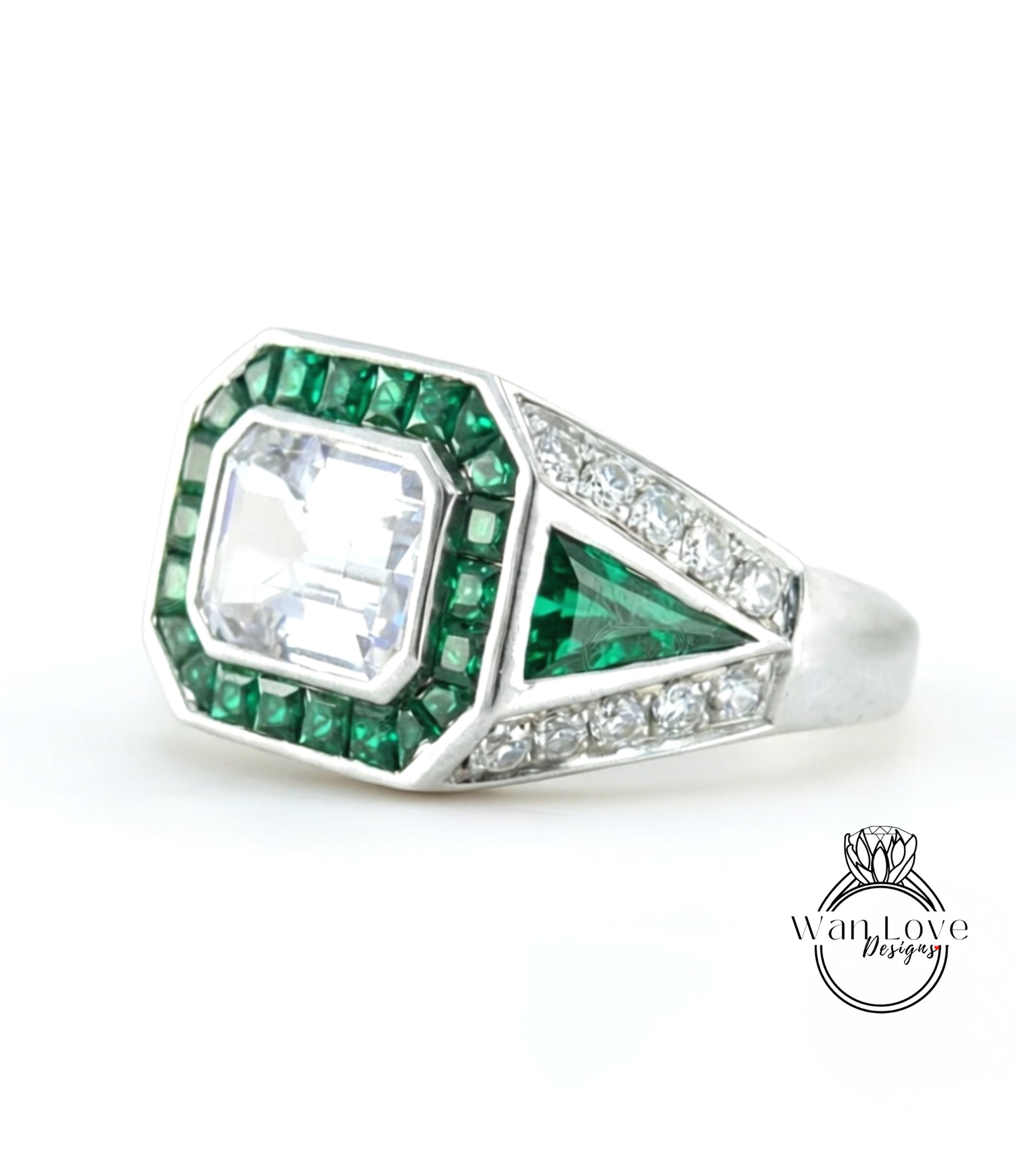A silver ring with a large clear gemstone, surrounded by smaller green gemstones, and a diamond accent.