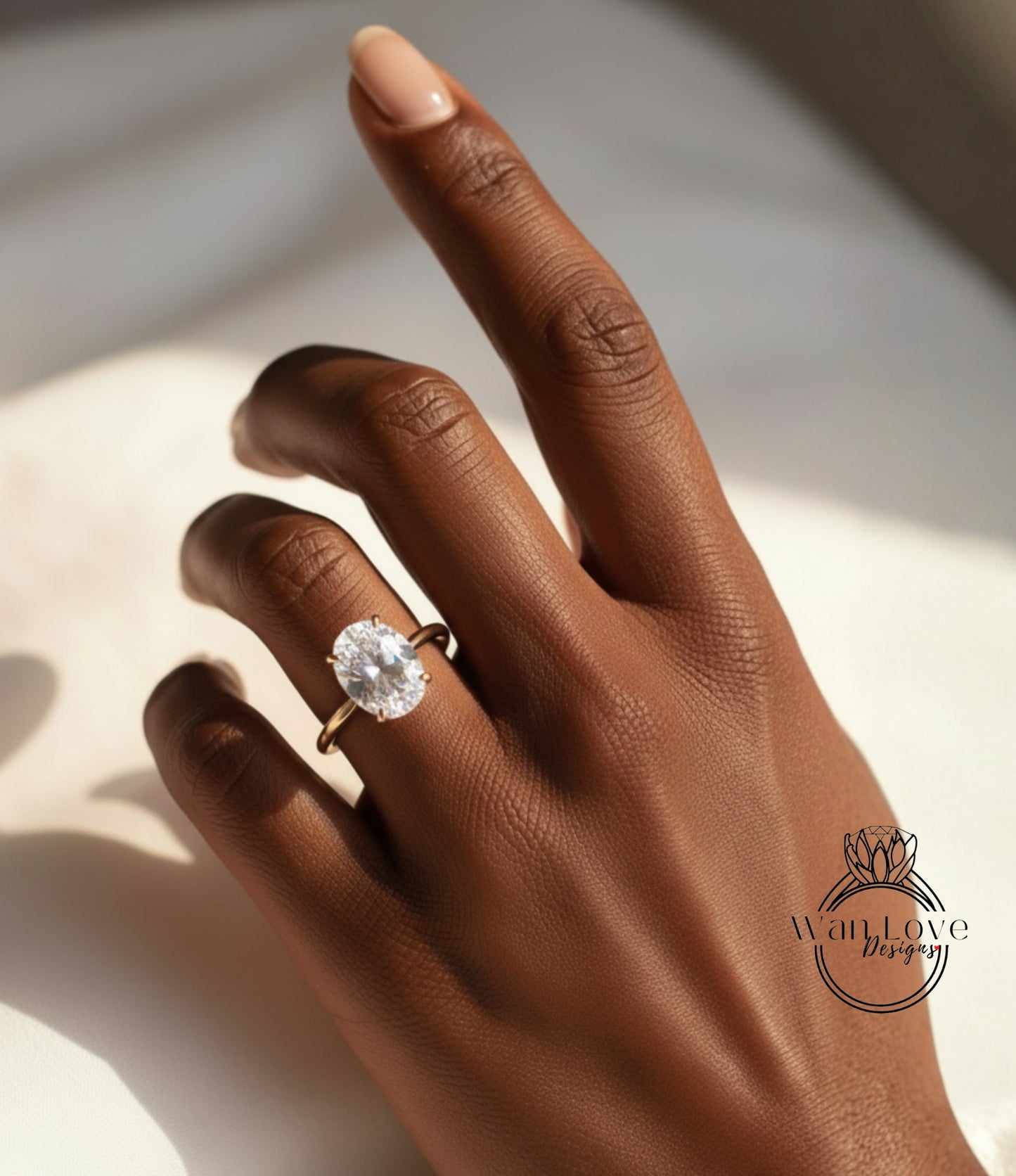 A close-up of a hand wearing a diamond engagement ring.