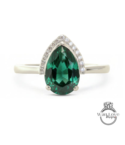 A silver ring with a large, green gemstone in the center.