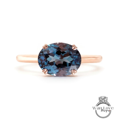 A rose gold ring with a large blue gemstone set in the center.
