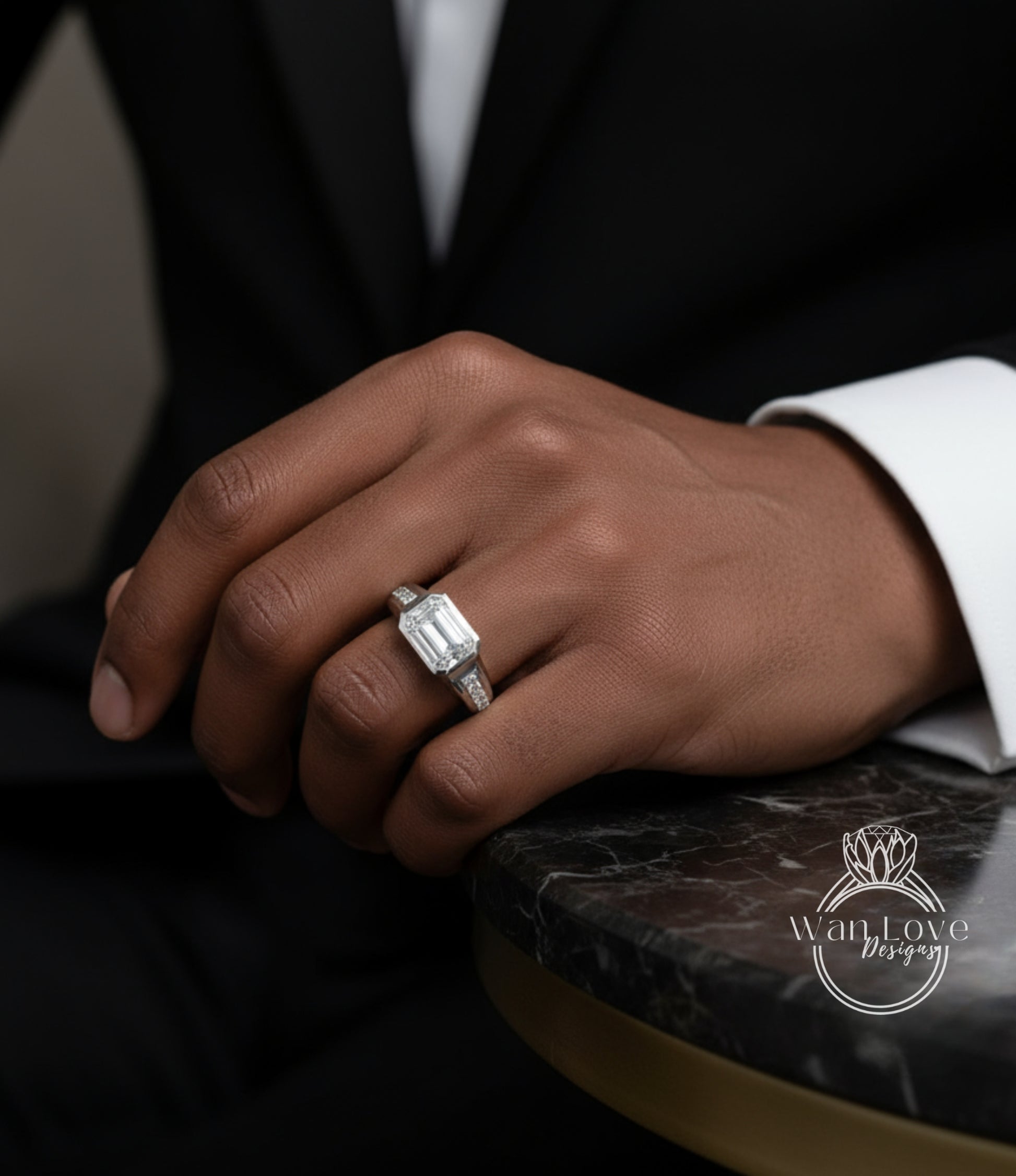 A close-up of a person's hand wearing a diamond engagement ring, resting on a marble surface.