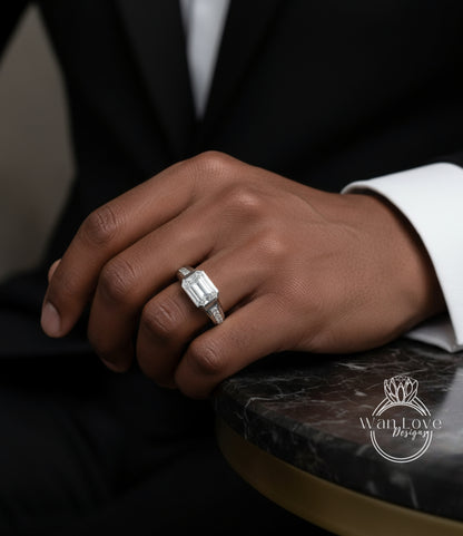 A close-up of a person's hand wearing a diamond engagement ring, resting on a marble surface.